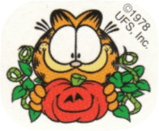 Garfield the cartoon cat facing the viewer while happily holding a jack o’ lantern surrounded by vines.